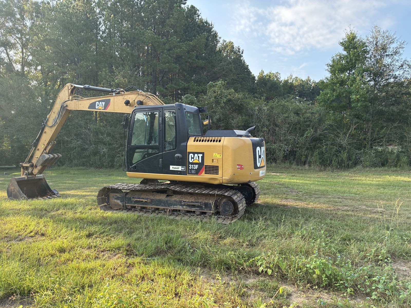 Side view of a Cat 313F L GC hydraulic excavator on level ground
